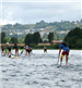 The Back of a Group Racing on Paddleboards