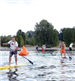 Group of Men Racing on Paddleboards