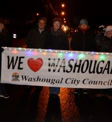 People Holding a We Love Washougal Banner in the Christmas Parade