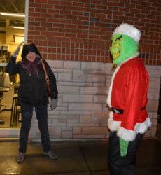 People Looking at the Grinch Figure