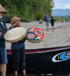 Man and Woman Playing Chinook Drums