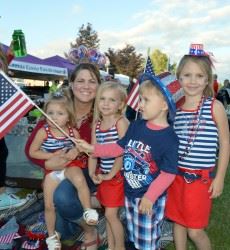 Kids and Woman Dressed in Red, White, and Blue
